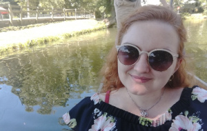 Hannah Armstrong wearing sunglasses in front of a river