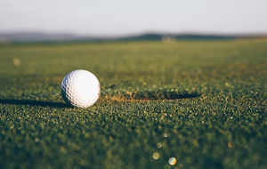 golf ball close to hole