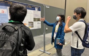 Chia-Hsin Tsai showing her poster to two AGU attendees