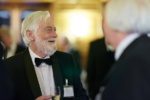 a man with a beard at a formal drinks reception