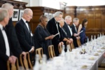 people at a formal dinner setting in hall