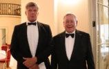 two men in formal evening wear smiling to camera