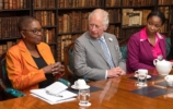 The Prince of Wales and valerie amos seated at a formal table
