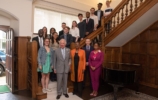 Prince Charles and valerie amos with a group of students standing on stairs