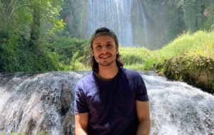 Carlos in front of a waterfall