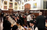 A large group of people at a formal dinner in hall