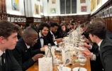 a large group of people at a formal dinner in hall