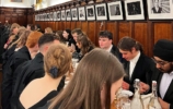 a large group of people at a formal dinner in hall