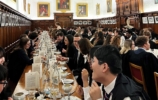 A large group of people at a formal dinner in hall