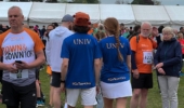 runners at the events village with tents