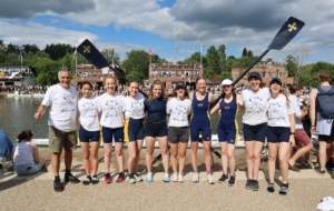 Lovisa as part of UCBC crew at Summer Eights with ergs behind them 