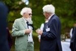 two smartly dressed elderly men in conversation