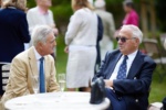 two smartly dressed elderly men in conversation