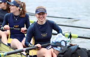 Woman wearing UCBC kit in boat