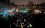 Main quad at night with many people standing around