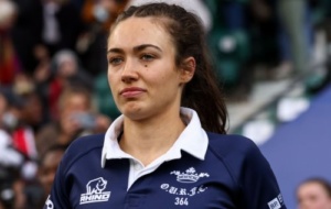 Woman in rugby kit looking determined