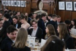 people seated at tables for formal dinner