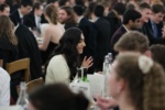 people seated at tables for formal dinner