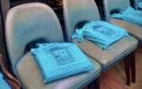 Blue bags which say From Bombay with Love on chairs