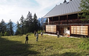 An alpine lodge with a background of fir trees
