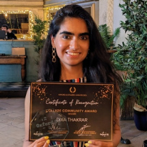 Woman with long black hair holding a certificate