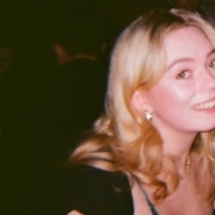 Smiling blonde woman in film photo