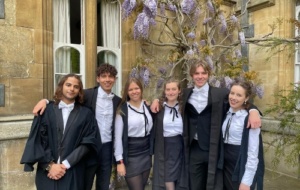 Group of friends on matriculation standing in front of Univ's wisteria 