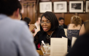 Black woman speaking at formal dinner in Univ hall
