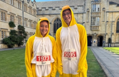 Team Univ: Town and Gown 2025 - two runners in bird costumes