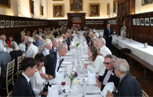 Milestones Anniversary - People seated at long tables in the hall