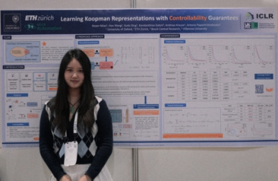 DPhil student Keyan Miao standing in front of a poster at the ICLR Conference in Rio de Janiero