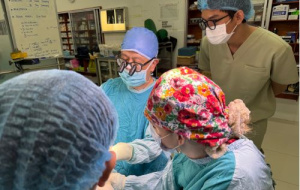 Surgeons operating on a patient.